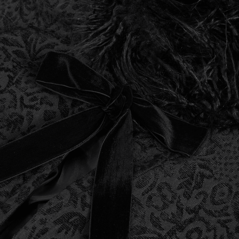 Close-up of gothic velvet long cape with fur hood and satin tie detail on the textured fabric.