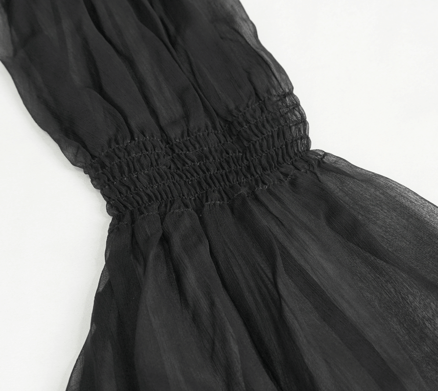 Detail of black sheer fabric with gathered smocking, perfect for vintage gothic fashion. Elegant and flowing design.