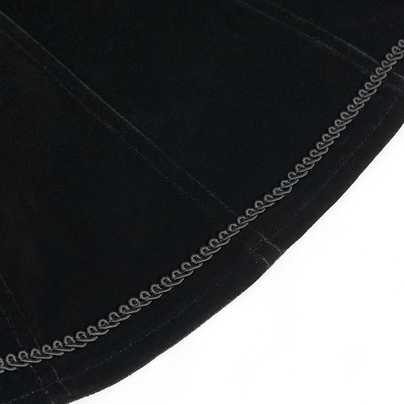 Detail of the hem of a gothic black velvet jacket showcasing decorative stitching and luxurious texture.