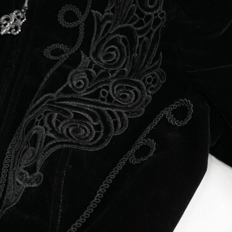 Close-up of black velvet jacket showing intricate lace appliqué and decorative stitching for gothic style.