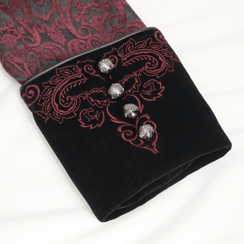 Close-up of gothic vintage coat sleeve with floral embroidery and decorative buttons in wine red and black.
