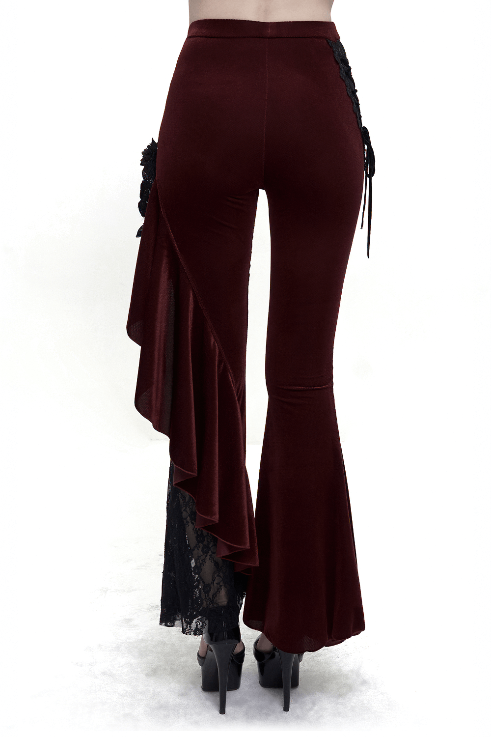 Back view of women's gothic wine red flare trousers with lace-up accents and ruffled details on the side.