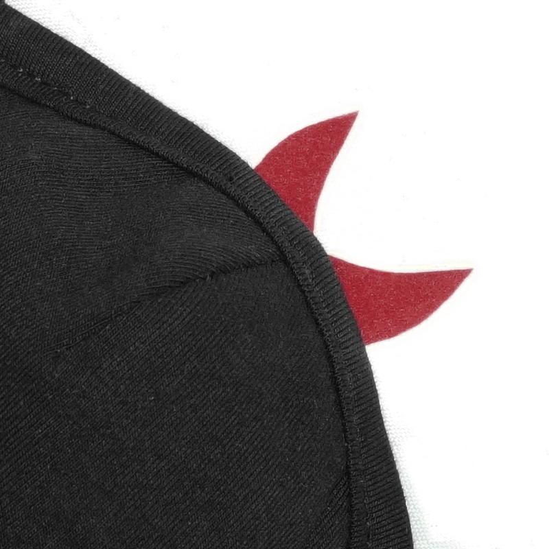 Close-up of the edge of a black gothic women's cotton mask featuring red wing accents.