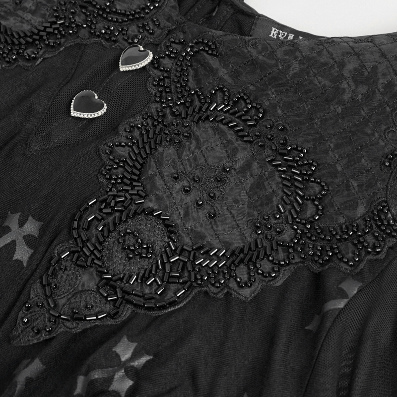 Close-up of a gothic dress featuring intricate beaded lace and heart-shaped embellishments on an off-shoulder design.