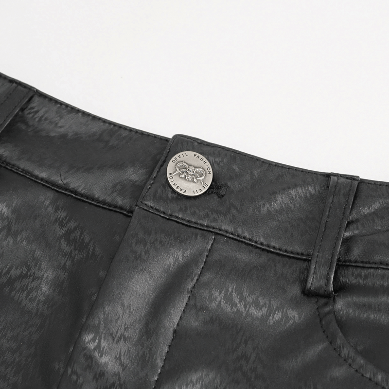 Close-up of gothic women's slim pants showing the front button detail in black PU leather fabric.
