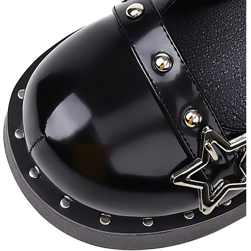 Close-up of Gothic women wedges pumps with silver rivets and star detail, showcasing shiny black patent leather.