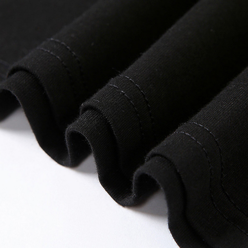 Close-up of black fabric with rolled sleeves and neat stitching, showcasing the quality of a gothic crop top.