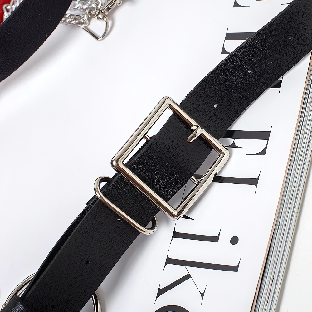 Close-up of a Gothic women's faux leather belt with metal buckle and chains, perfect for punk style outfits.