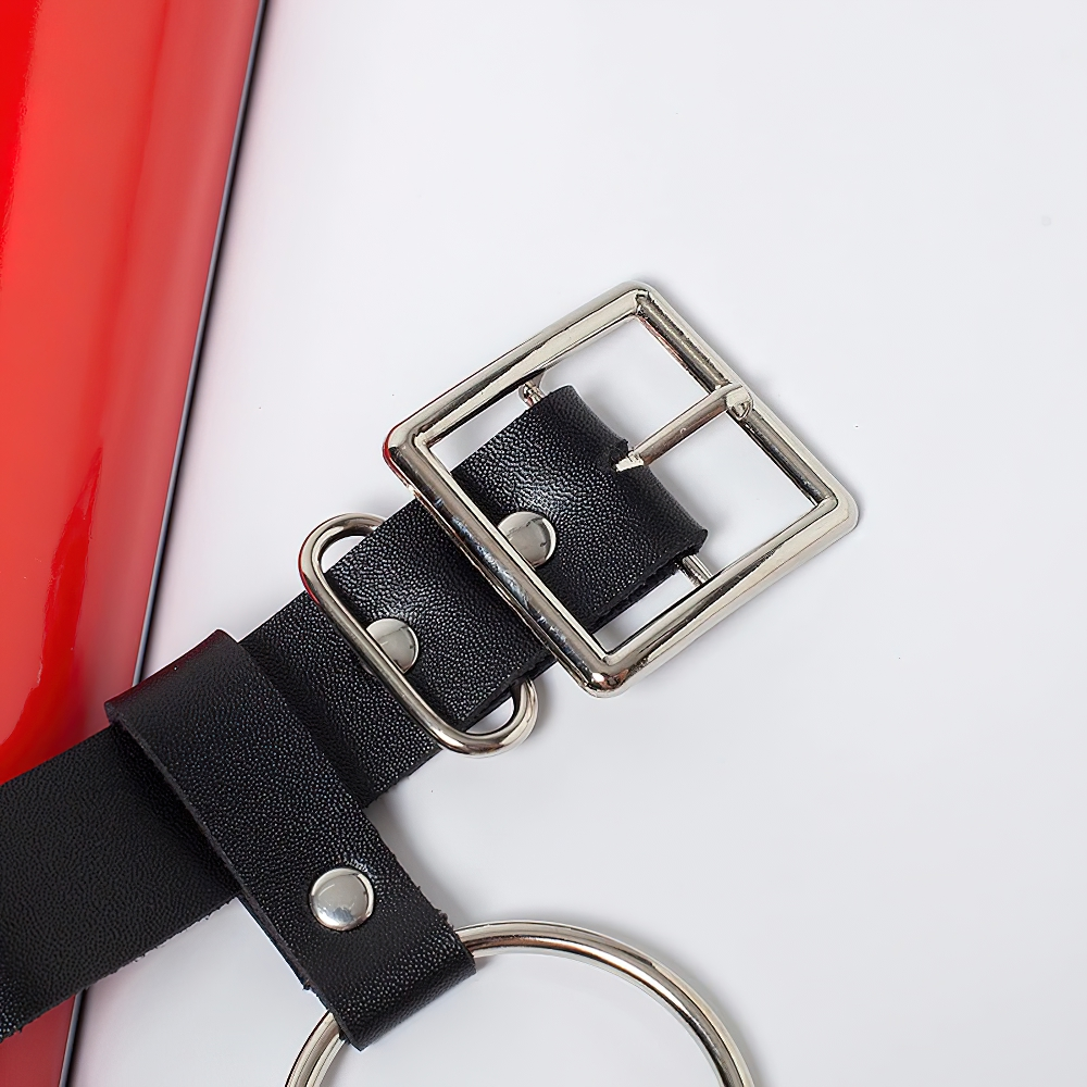 Close-up of a Gothic women's faux leather belt with metal buckle and rings, perfect for punk style outfits.