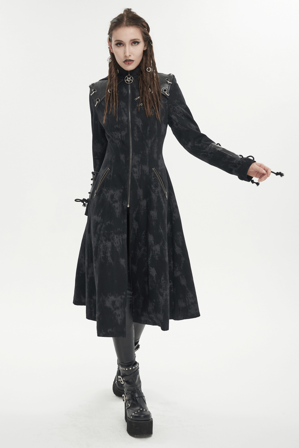 Gothic women's hooded coat features a dark edgy design, stylishly worn by a woman with unique accessories.