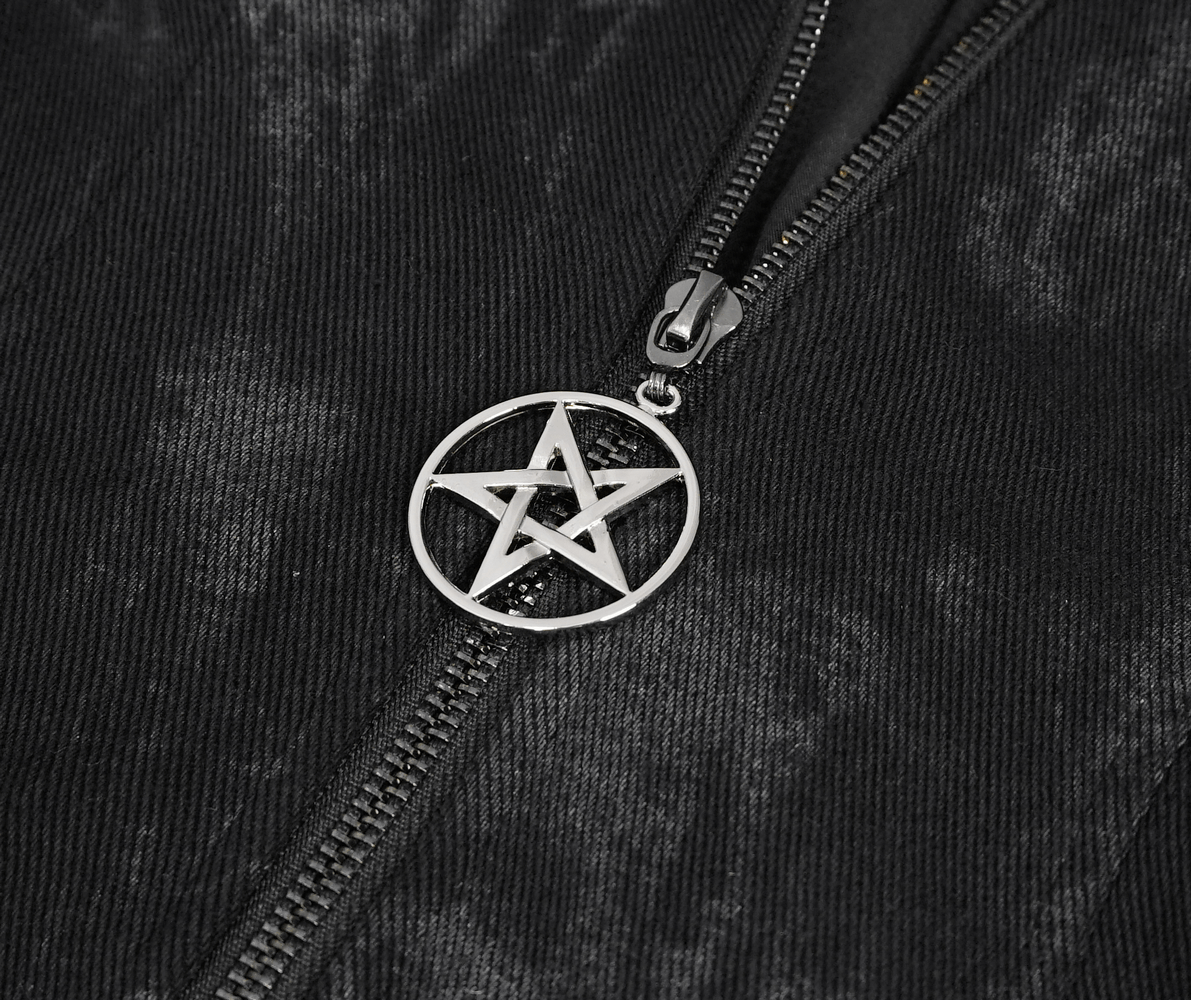 Close-up of a black zipper featuring a silver pentagram charm on a gothic women's hooded coat.
