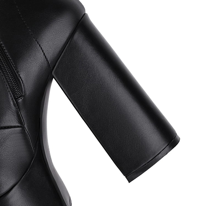 Detail of a Gothic women's high heel boot showcasing the sleek black patent leather and stylish chunky heel.