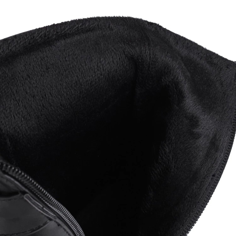 Interior view of Gothic women's patent leather high heel boots with soft black lining.