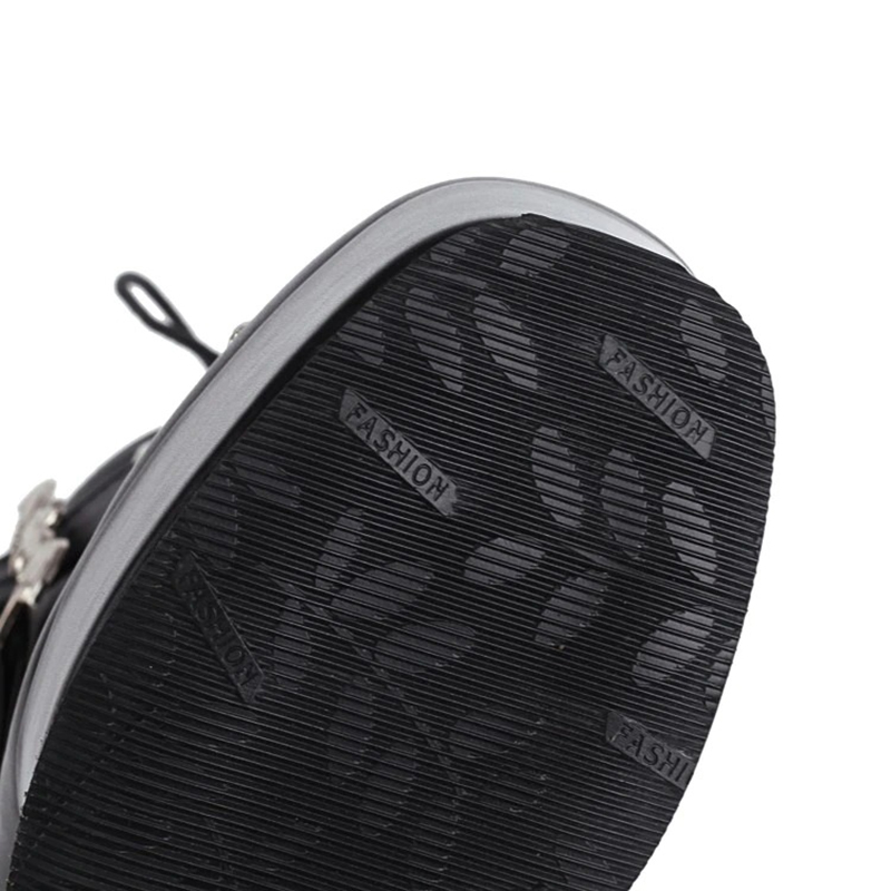 Stylish gothic women's patent leather boot sole with embossed 'FASHION' design.