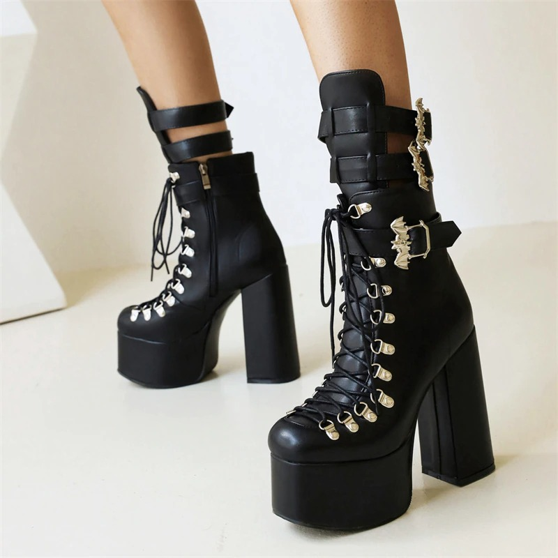 Gothic women's patent leather short boots featuring high heels, lace-up design, and bat buckle detail.