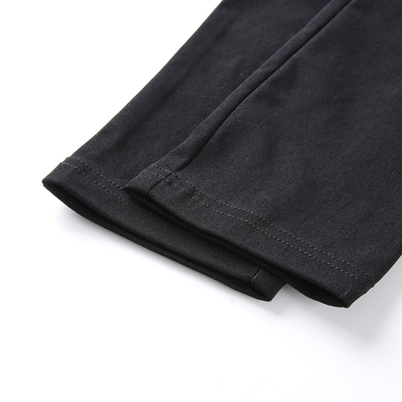 Close-up of Gothic women's pencil pants showing the sleek black fabric and hemline detail for a stylish look.