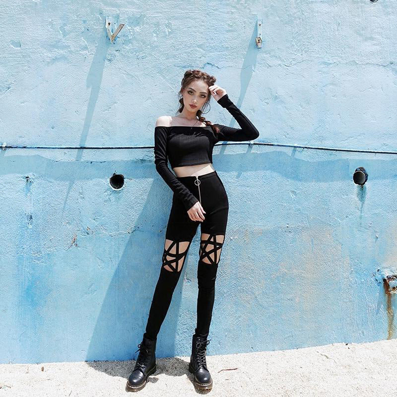 Gothic women's high waist pencil leggings with pentagram design, stylishly paired with a black crop top.