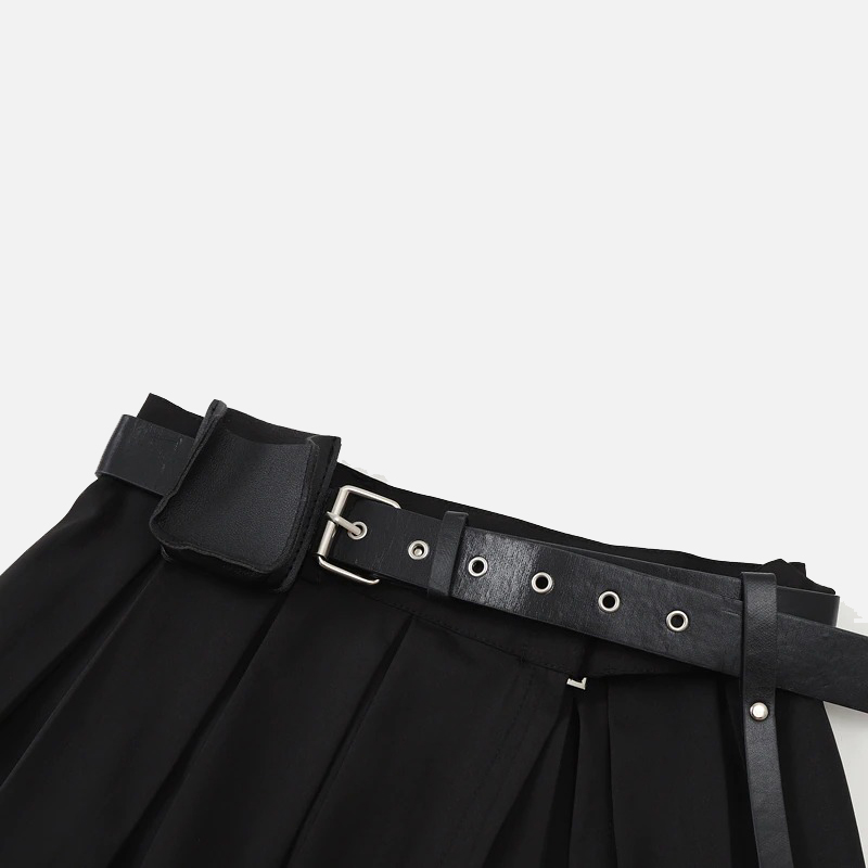 Close-up of a black pleated mini skirt with a stylish belt, perfect for a gothic outfit.