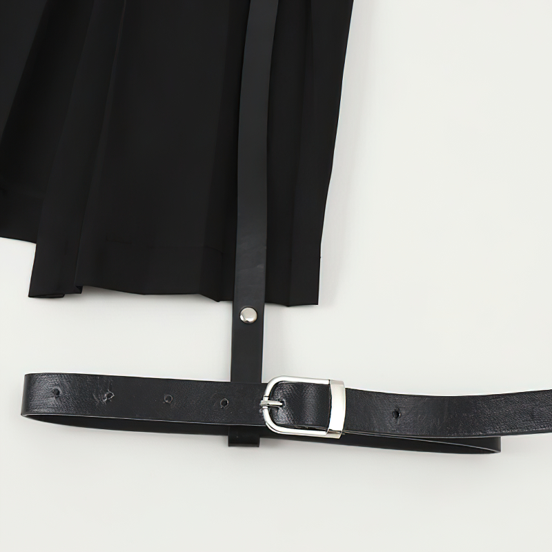 Close-up of a black gothic mini skirt with pleats and a stylish belt, highlighting its edgy design and stylish details.