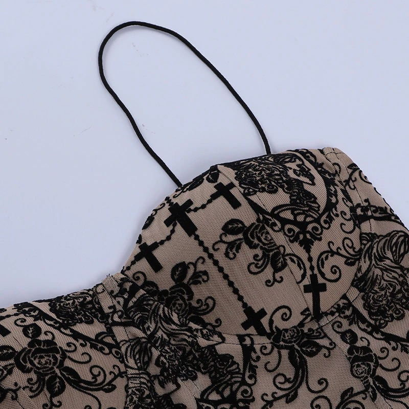 Close-up of a gothic women's top featuring a delicate floral and cross print, showcasing its elegant backless design.