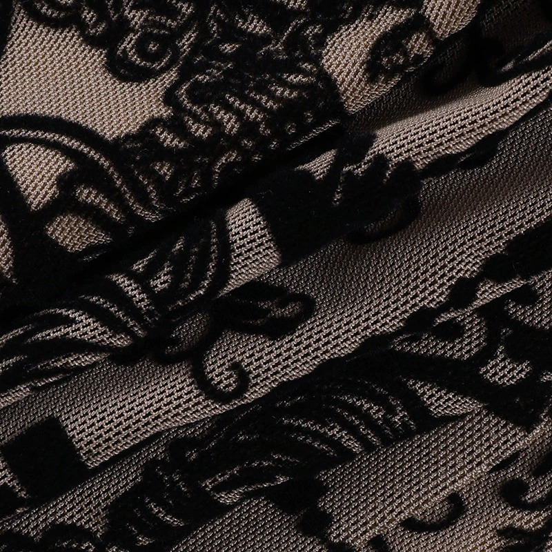 Close-up of intricate black floral lace fabric, perfect for gothic women's tops with a vintage aesthetic.