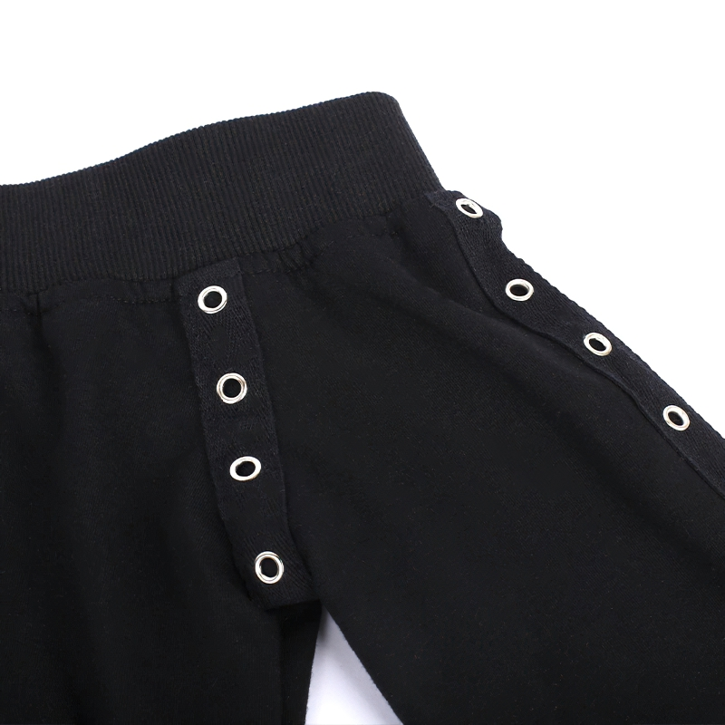 Close-up of black pants featuring silver eyelets, perfect for adding a gothic touch to any outfit.