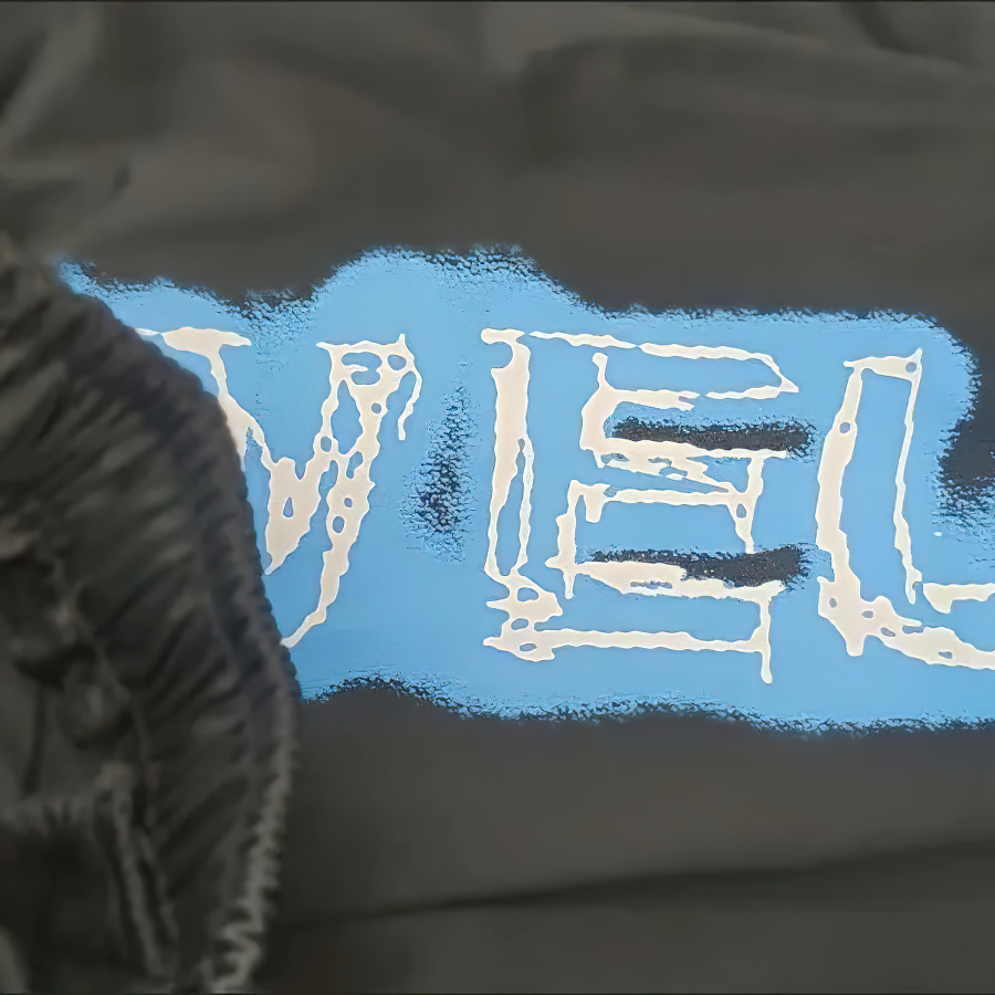 Gothic women's clothing featuring bold blue graphic print on black fabric, ideal for a trendy oversized look.