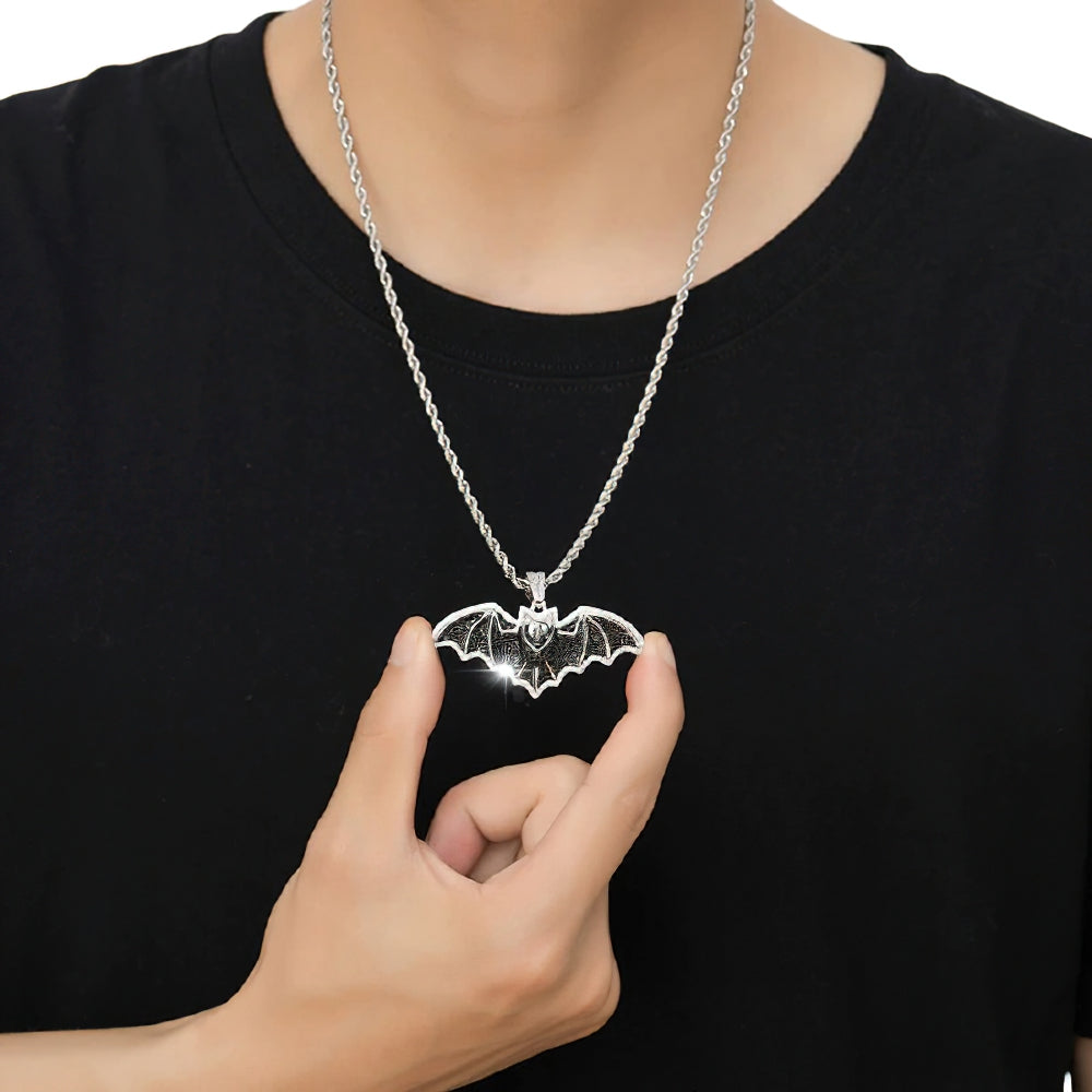Silver gothic bat pendant worn on a black shirt, showcasing punk rock motorcycle jewelry for men and women.