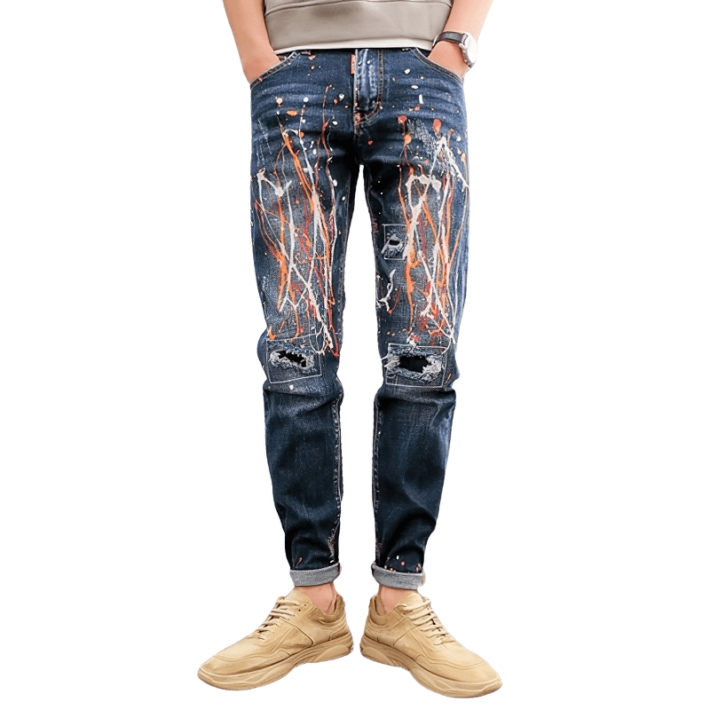 Men's graffiti ripped skinny jeans with bold paint splatter design, perfect for an alternative style wardrobe.