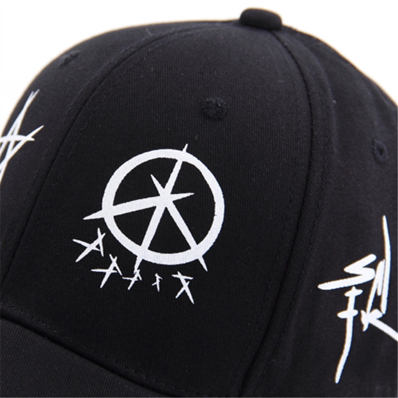 Close-up of black baseball cap featuring white punk graphics and an anarchy symbol, perfect for grunge fashion enthusiasts.