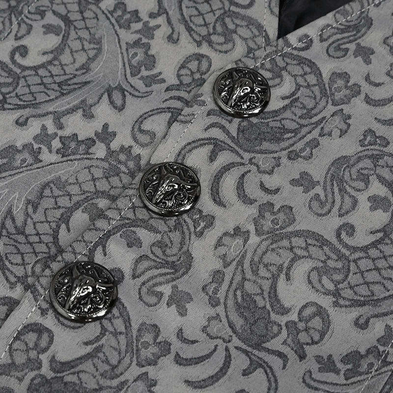 Close-up of gray jacquard fabric with intricate patterns and decorative black buttons on a gothic waistcoat.