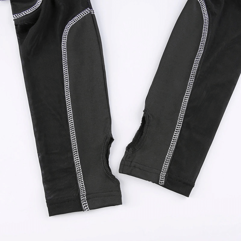 Close-up of black stretch fabric sleeves with open cuts and contrasting white stitching details.