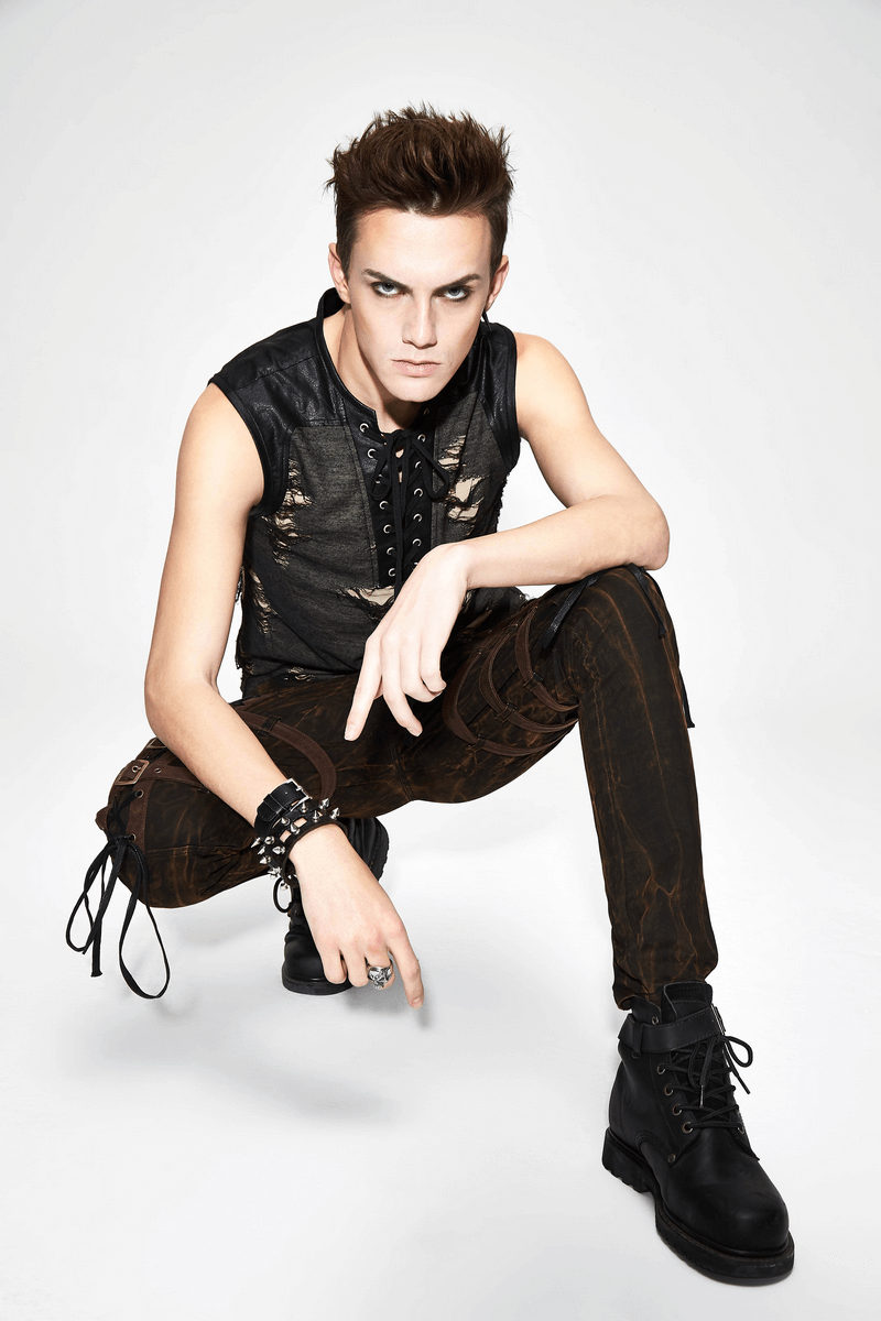 Stylish model showcasing a men's grunge tank top with crisscross lacing and distressed details, exuding edgy vibes.