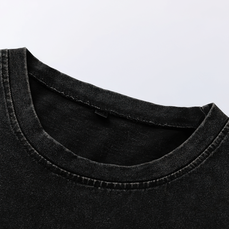 Close-up of the collar of a grunge-style black cotton tank top with a soft texture and detailed stitching.