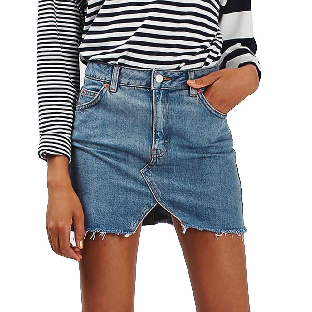 Grunge style high waist denim mini skirt with pockets, paired with a striped long sleeve top.