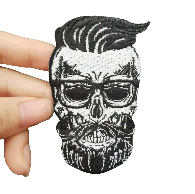 Stylish hairy skull patch with glasses and beard, perfect for decorating jackets or as a gothic accessory.