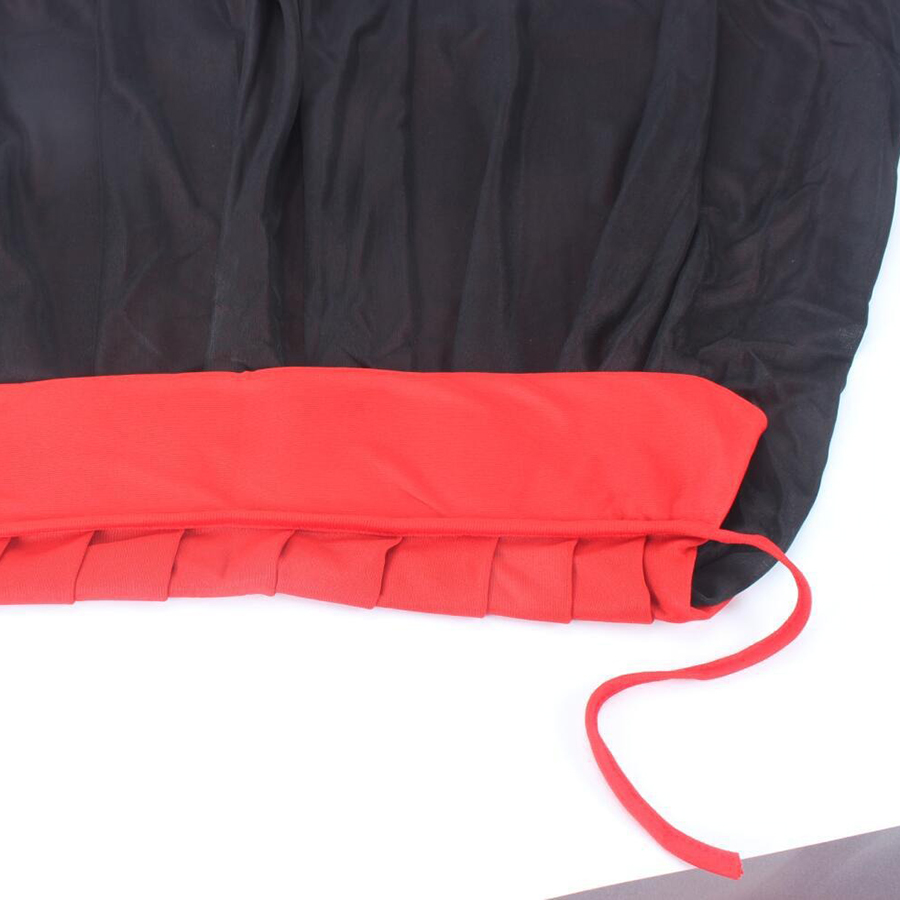 Close-up of a Dracula-style Halloween cape showcasing black fabric with a vibrant red collar.