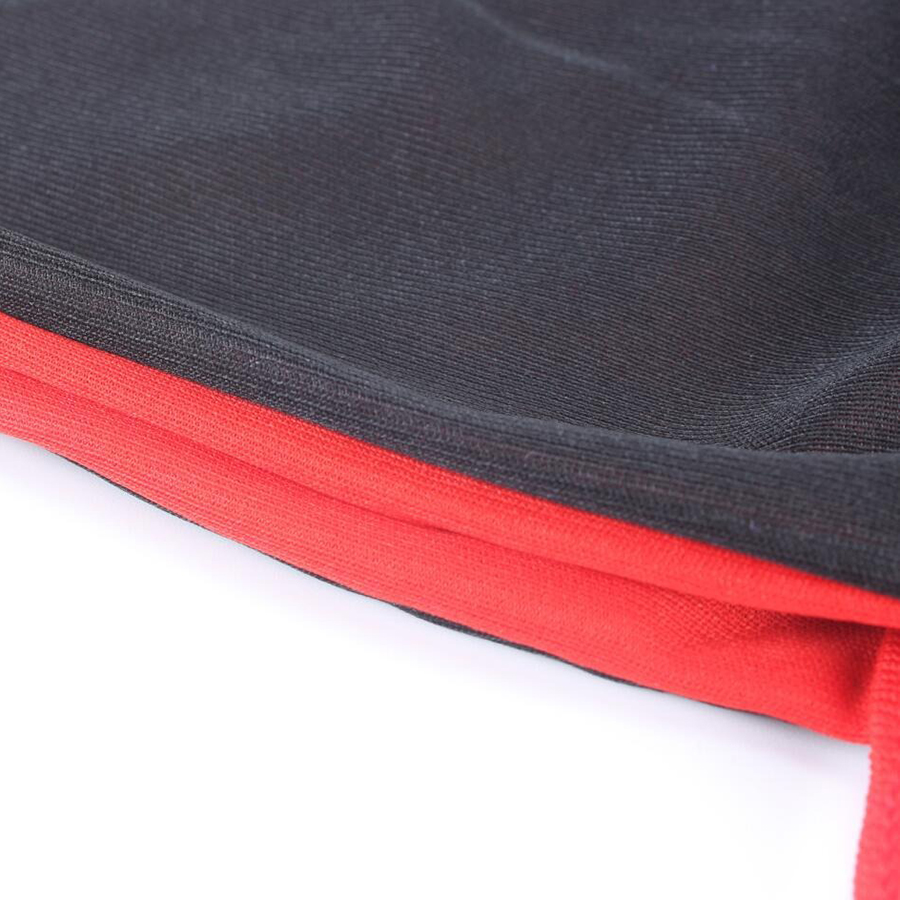 Close-up of the black and red fabric detailing of a vampire cape for Halloween costumes.