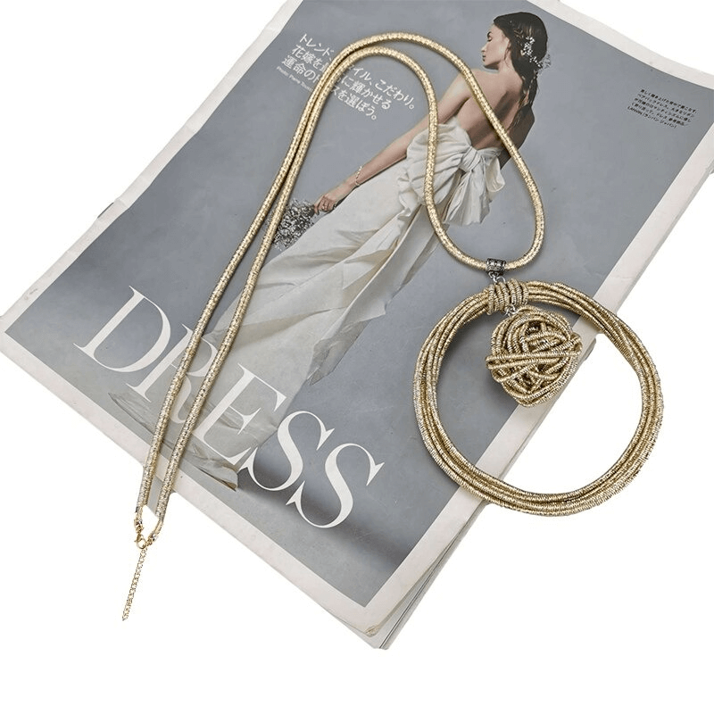 Handmade punk women's necklace with round pendant displayed on a fashion magazine cover.