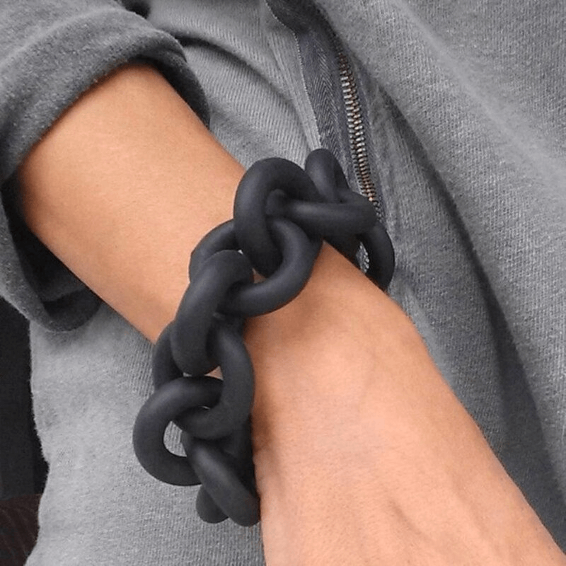 Handmade black rubber bangle on wrist, showcasing punk fashion style for women.