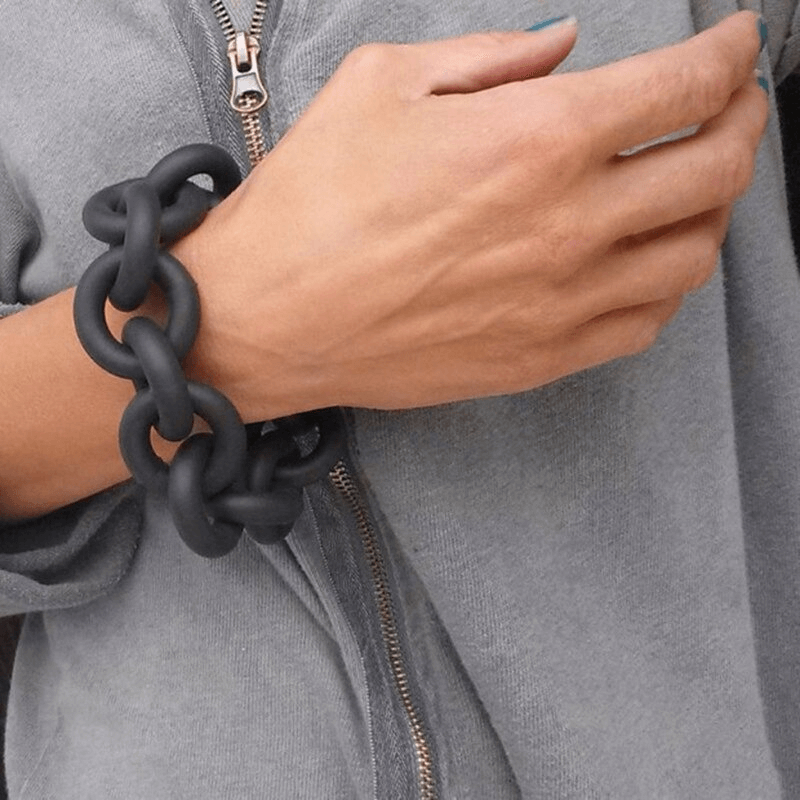 Handmade black rubber bangles worn on wrist, perfect punk fashion accessory for women.