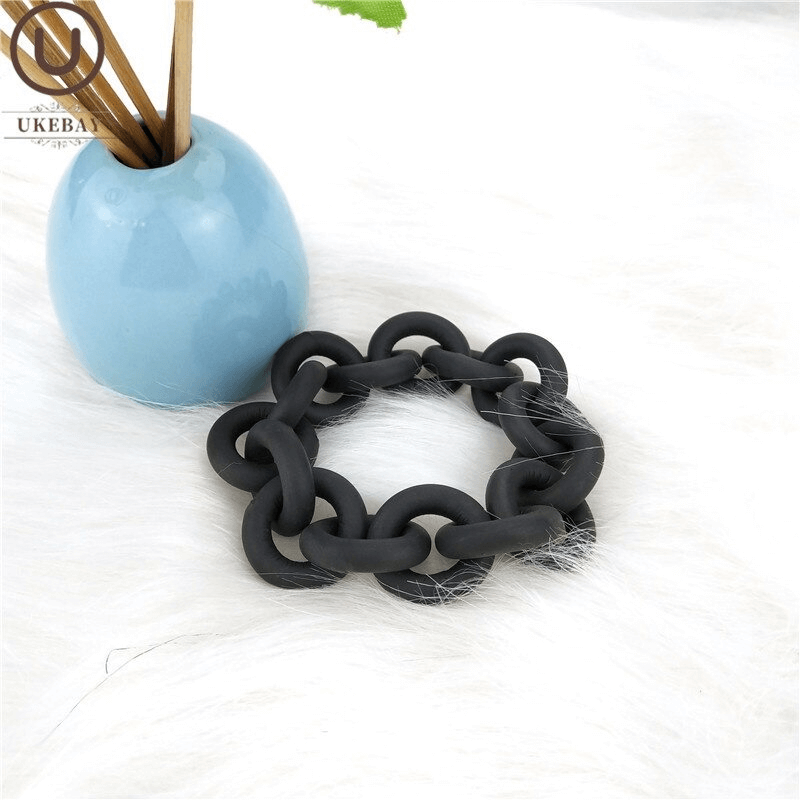 Handmade black rubber bangle on white fur, perfect punk accessory for women's fashion.
