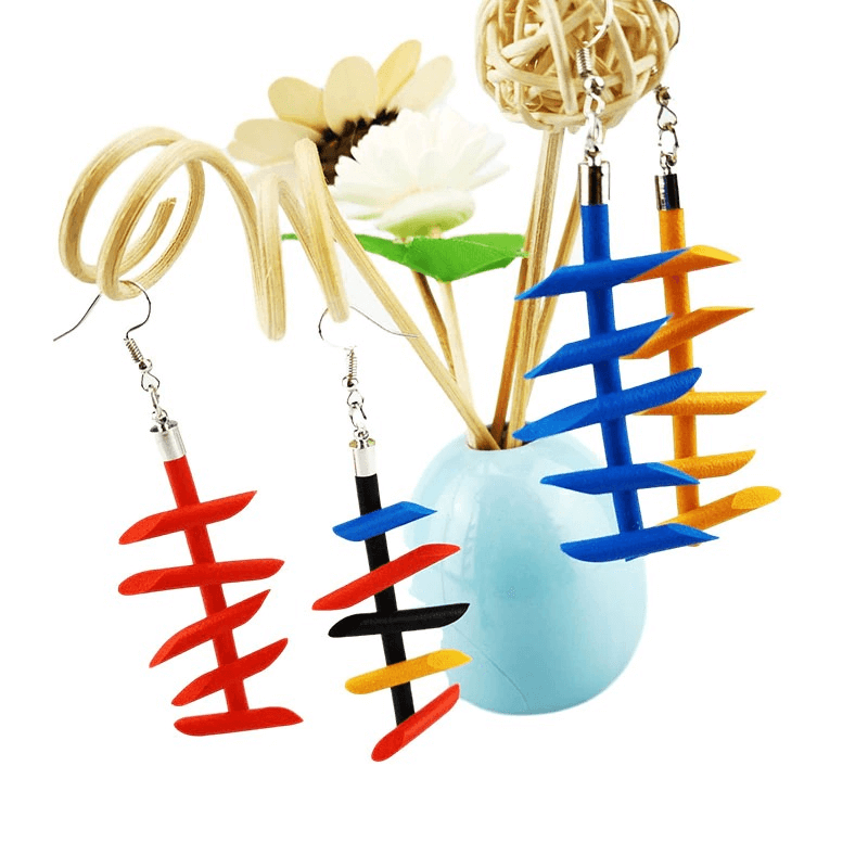 Colorful handmade rubber long earrings in gothic style, featuring blue, red, black, and yellow designs displayed with decorative vase.
