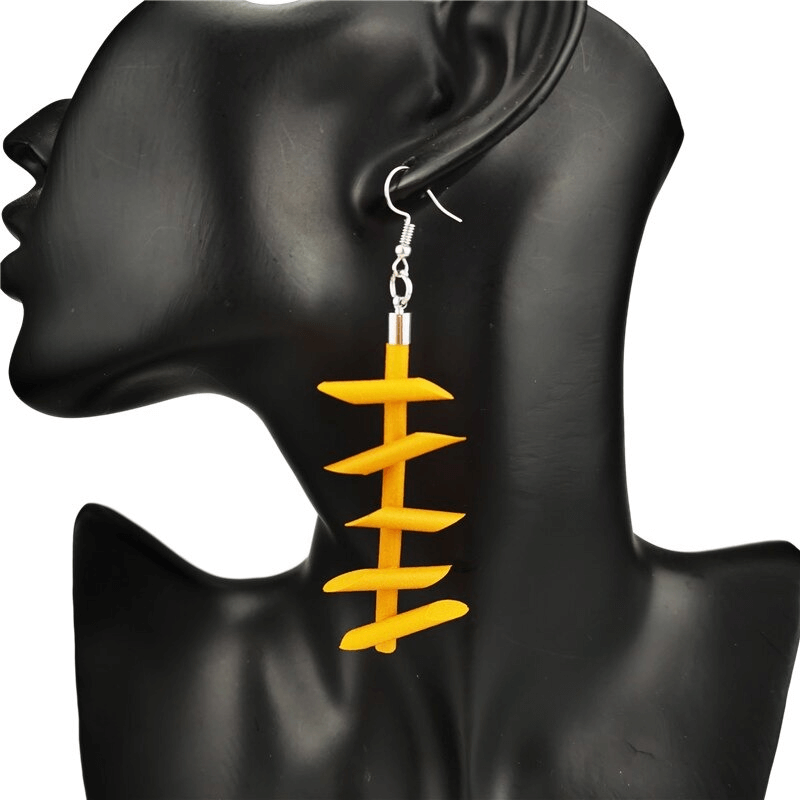 Handmade yellow rubber gothic earrings on a model showcasing unique silicone jewelry design.