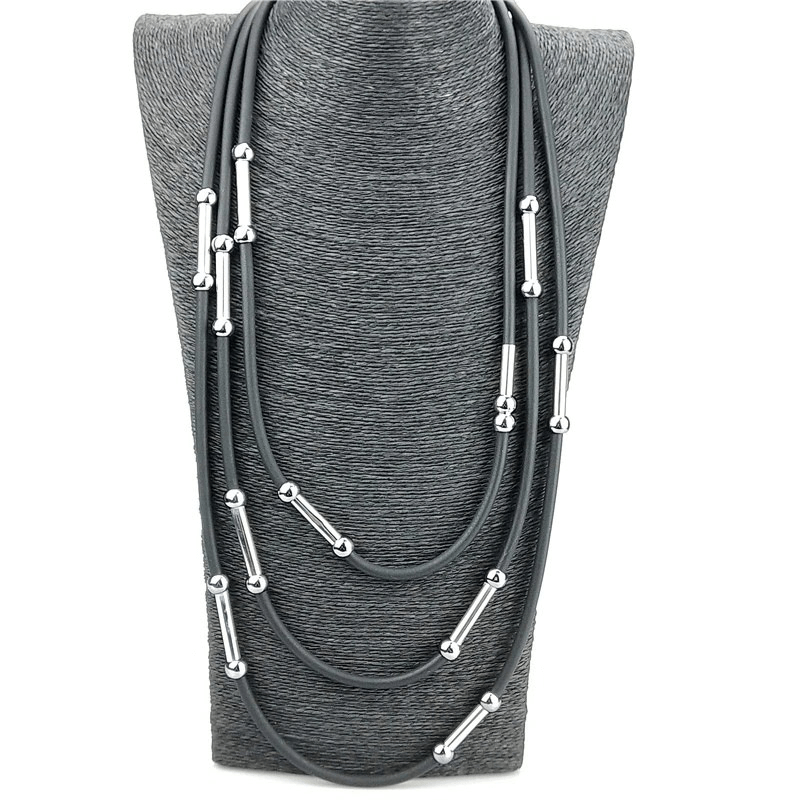 Handmade black rubber necklace with silver accents on a display bust, perfect for casual bohemian style.