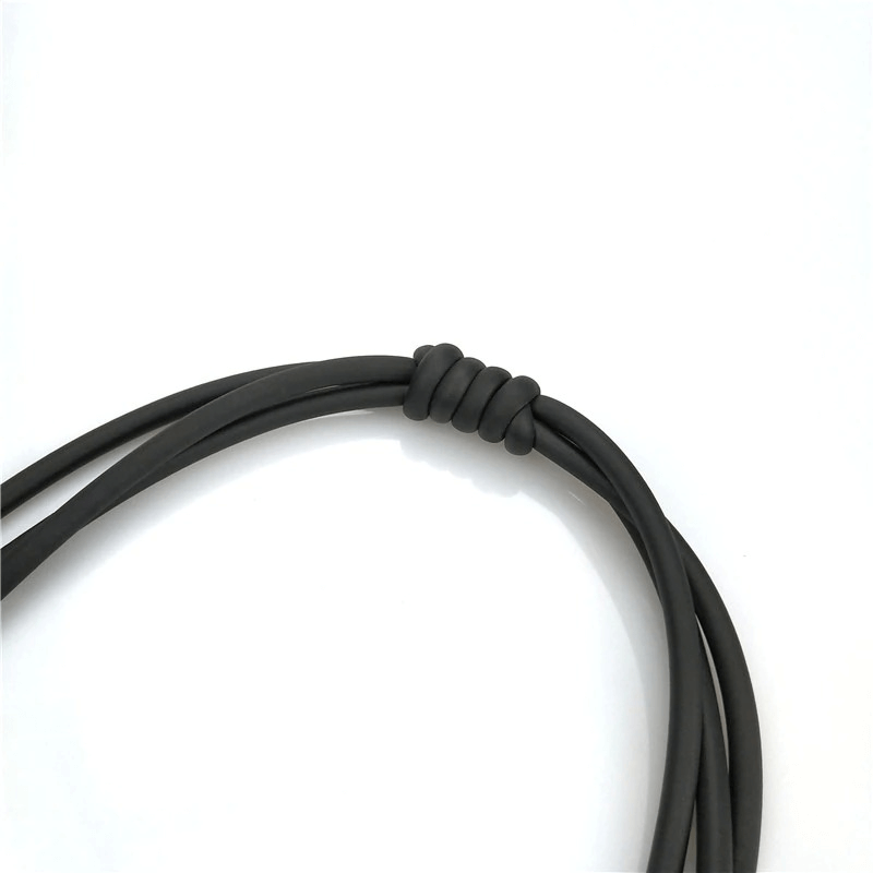 Close-up of handmade black rubber necklace showcasing a stylish knot design, perfect for casual boho outfits.