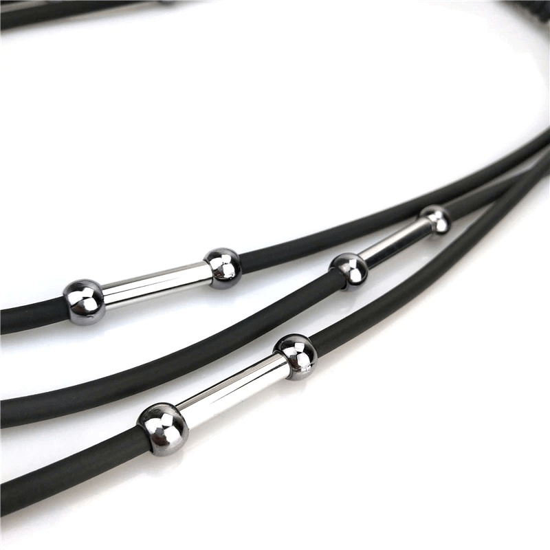 Close-up of handmade black rubber necklace with stylish silver bead accents, perfect for bohemian casual wear.