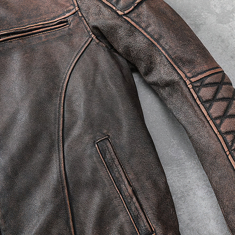 Close-up of vintage brown genuine leather motorcycle jacket sleeve with detailing and pockets.