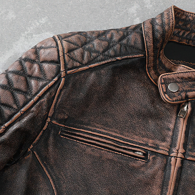 Vintage brown leather motorcycle jacket with quilted detailing and a zip pocket for a stylish biker look.