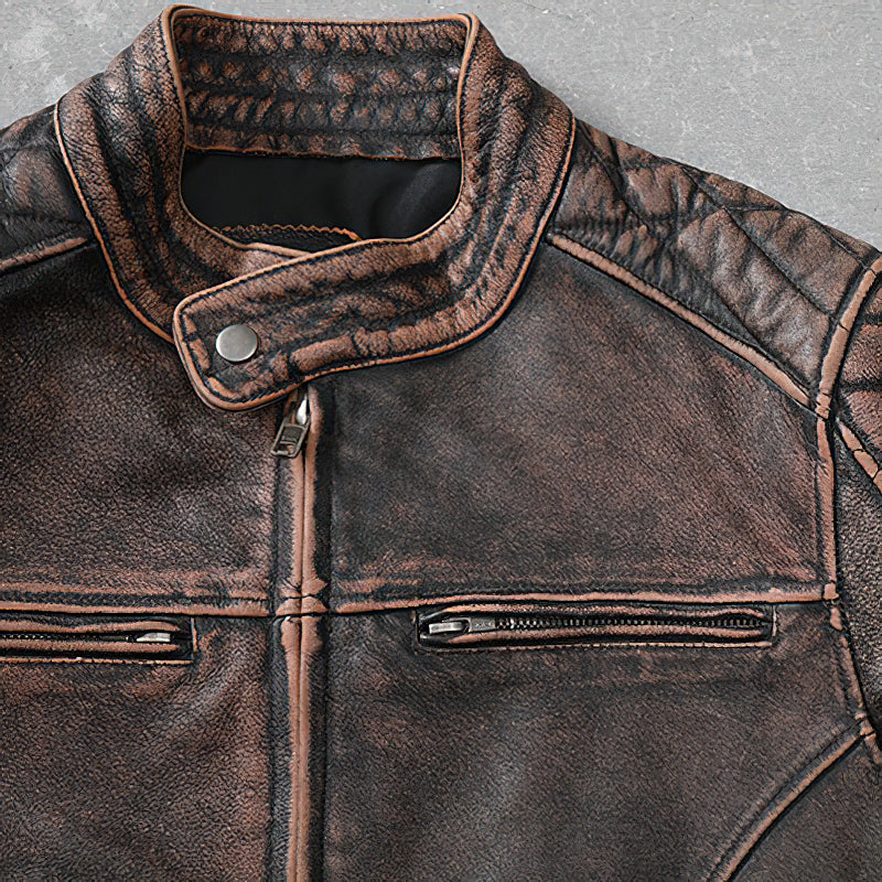 Close-up of a heavy genuine leather motorcycle jacket in vintage brown with O-neck collar and zippers.